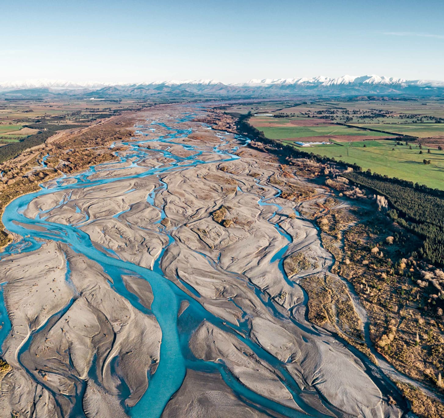 New Zealand braided river landscape with mountains